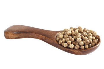 Coriander seeds in wood spoon on white background