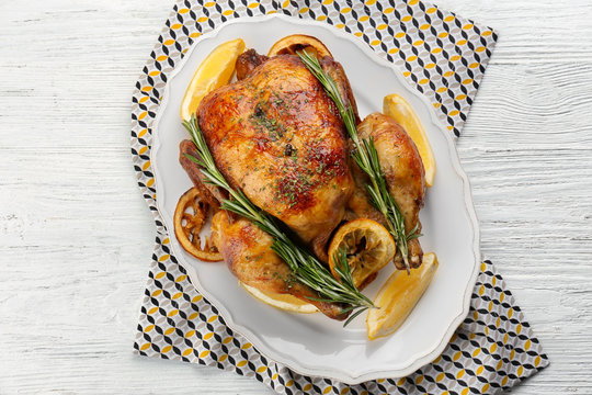 Homemade Baked Chicken With Lemon And Rosemary On Table