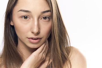 Obraz premium 1046817 Beautiful woman has put her hand to her face on an isolated background portrait