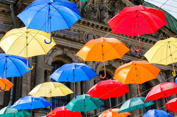 Fototapeta na wymiar The sky of colorful umbrellas. Street with umbrellas.