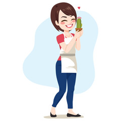 Young happy standing woman holding cactus enjoying gardening hobby