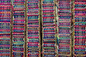 Colorful background of name embroidered bracelets in columns