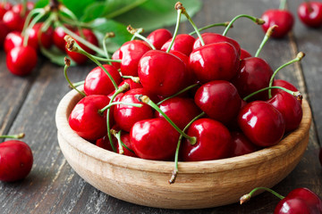 Fresh cherry in a wooden bowl
