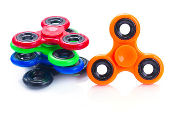 multicolored fidget spinners isolated on white background, popular relaxing toy, generic design