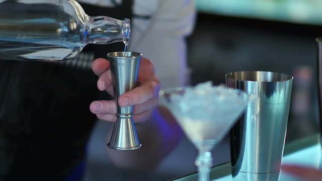 Barman prepares alcoholic cocktail