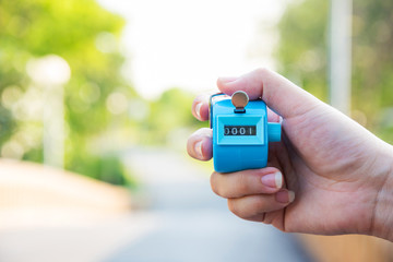 woman hand holding counter click on street background