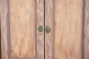 Two brown doors on buffet, closed.