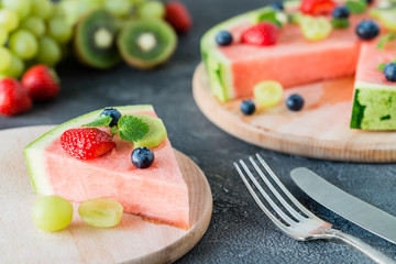 Watermelon pizza slice with fruits, dark background