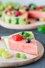 Watermelon pizza slice with fruits, dark background