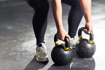 Kettlebell on floor. Girl training in gym