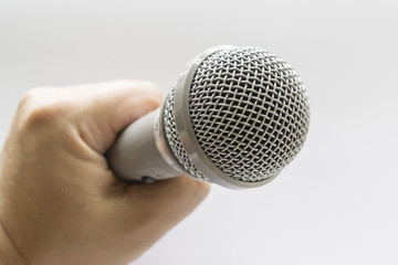 Close-up Of Hand Holding Microphone On White Background