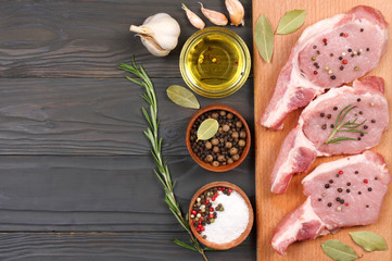 fresh raw meat with spices on wooden table. top view with copy space