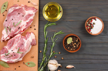 fresh raw meat with spices on wooden table. top view with copy space