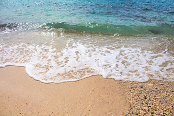 Seashore line with sand beach and sea wave. Turquoise blue tropical sea lagoon for perfect vacation.