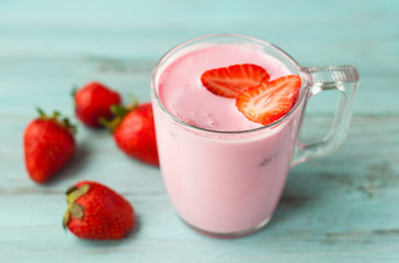 Berry yogurt, smoothies with strawberries on a wooden background, diet food.