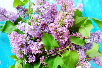 Beautiful lilac on a blue wooden background