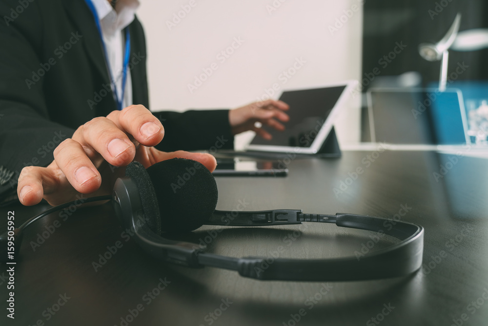 Aufkleber Man using VOIP headset with digital tablet and laptop computer as concept communication,it support,call center and customer service help desk with glass reflected view