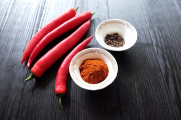 Red hot chile pepper on black background with spices