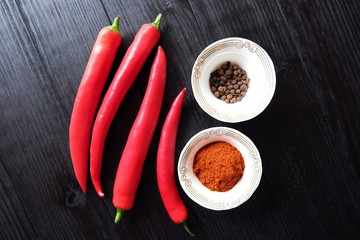 Red hot chile pepper on black background with spices