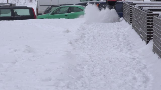 Sweeper man removing snow with snowblower after snowstorm in morning. 4K