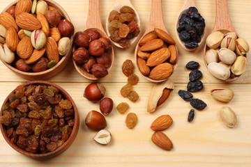 mix almonds, cashew nuts, hazelnut, peanuts, walnuts, pistachio on wooden background. Top view