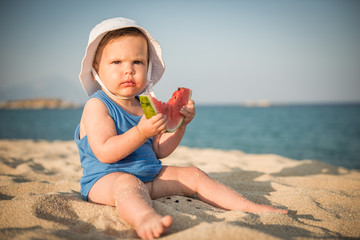 Little caucasian girl eating watermelon