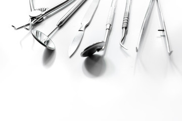 dentistry with dentist tools close up on white background space for text