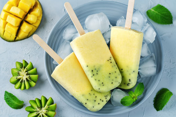 Kiwi mango ice cream with fruits and ices