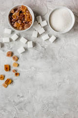 variety of sugar in bowls on gray table background top view space for text