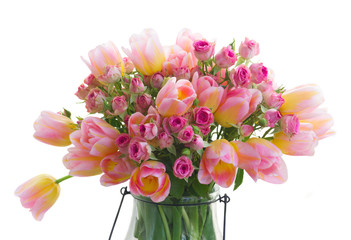Bouquet of fresh pink and yellow tulips and roses flowers close up isolated on white background