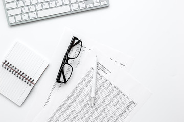 business accounter work with taxes and keyboard on white office desk top view mock up