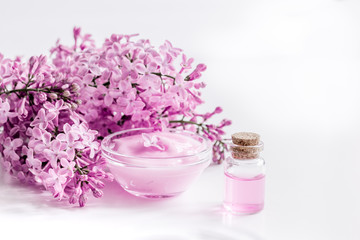 lilac natural cosmetic set for spa with cream white table background