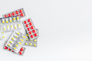 doctor's work desk in hospital with pills white background top view mockup