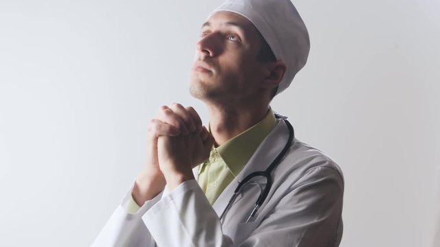 The doctor prays to the god. Powerlessness of medicine. Religion and medicine.
