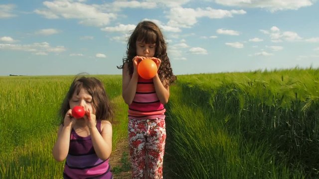 Children inflate balloons.