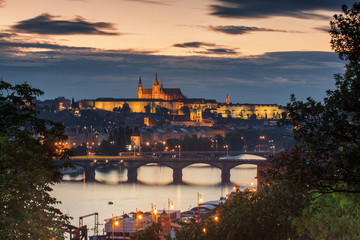 Fototapeta na wymiar Prague Skyline after Dark..With Prague Castle Complex, St. Nicholas Cathedral, Prague Jezulatko church, Vltava river and Naplavka.