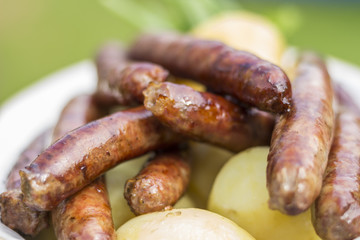 Grilled sausages with a boiled potatoes on a plate
