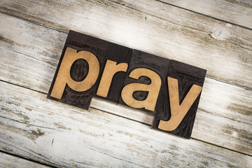 Pray Letterpress Word on Wooden Background