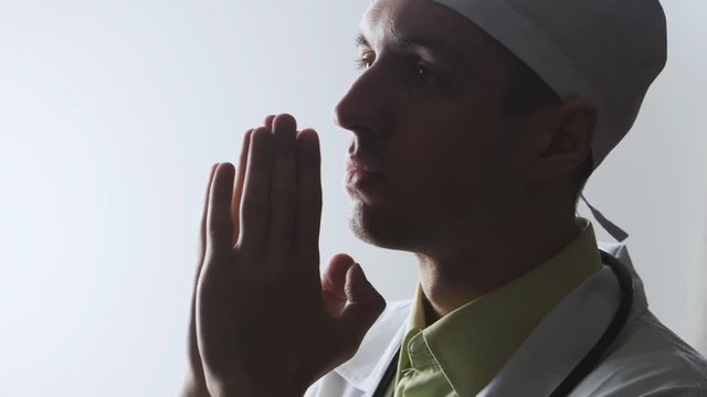 The doctor prays to the god. Powerlessness of medicine. Religion and medicine.