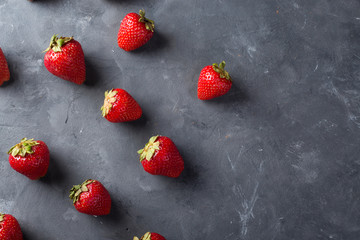 Strawberry. Fresh strawberry on dark background . Red strawberry. Loosely laid strawberries in different positions. Copyspace.