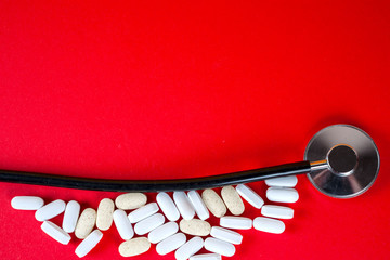 Pills ,tablets and stethoscope on white background