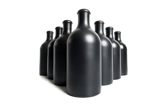 Matte black bottles on a white background close-up..