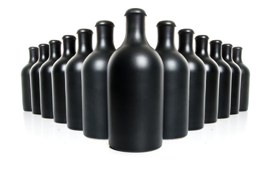 Set of black clay bottles on a white background..