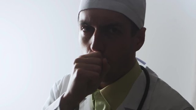 The doctor coughs. Sick medical worker.