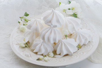 Obraz na płótnie Canvas Light air vanilla meringue on a white plate