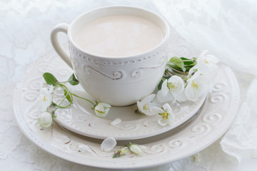 Masala tea chai latte homemade traditional Indian sweet milk with spices beverage in porcelain cup on wooden table background