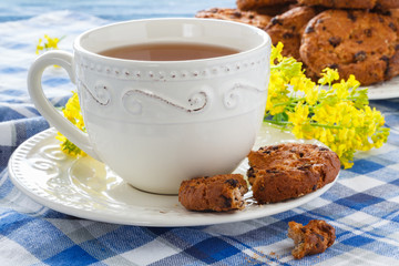 Cup of tea with oatmeal cookies on a wooden background