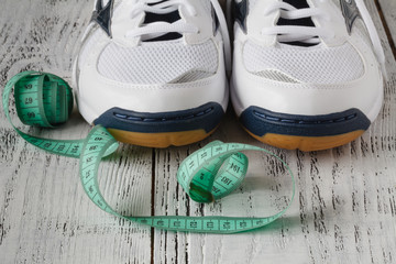 Fototapeta na wymiar Pair of sneakers isolated on the reclaimed wood background