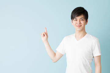 portrait of young asian man isolated on blue background