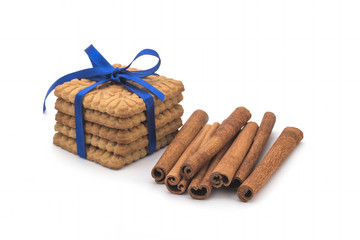Biscuits, cinnamon sticks on white background